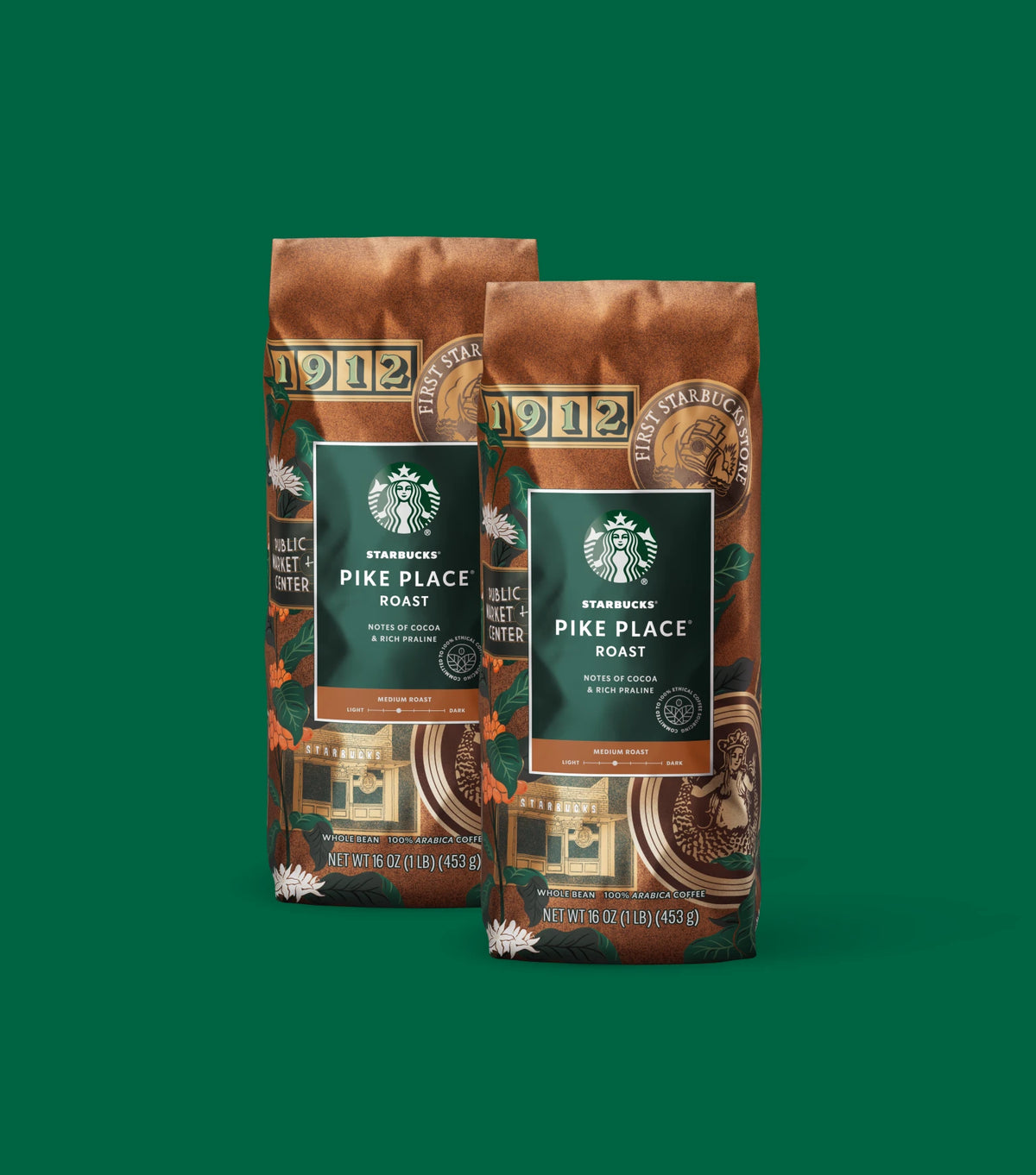 Two Starbucks Pike Place Roast coffee bags on a green background.