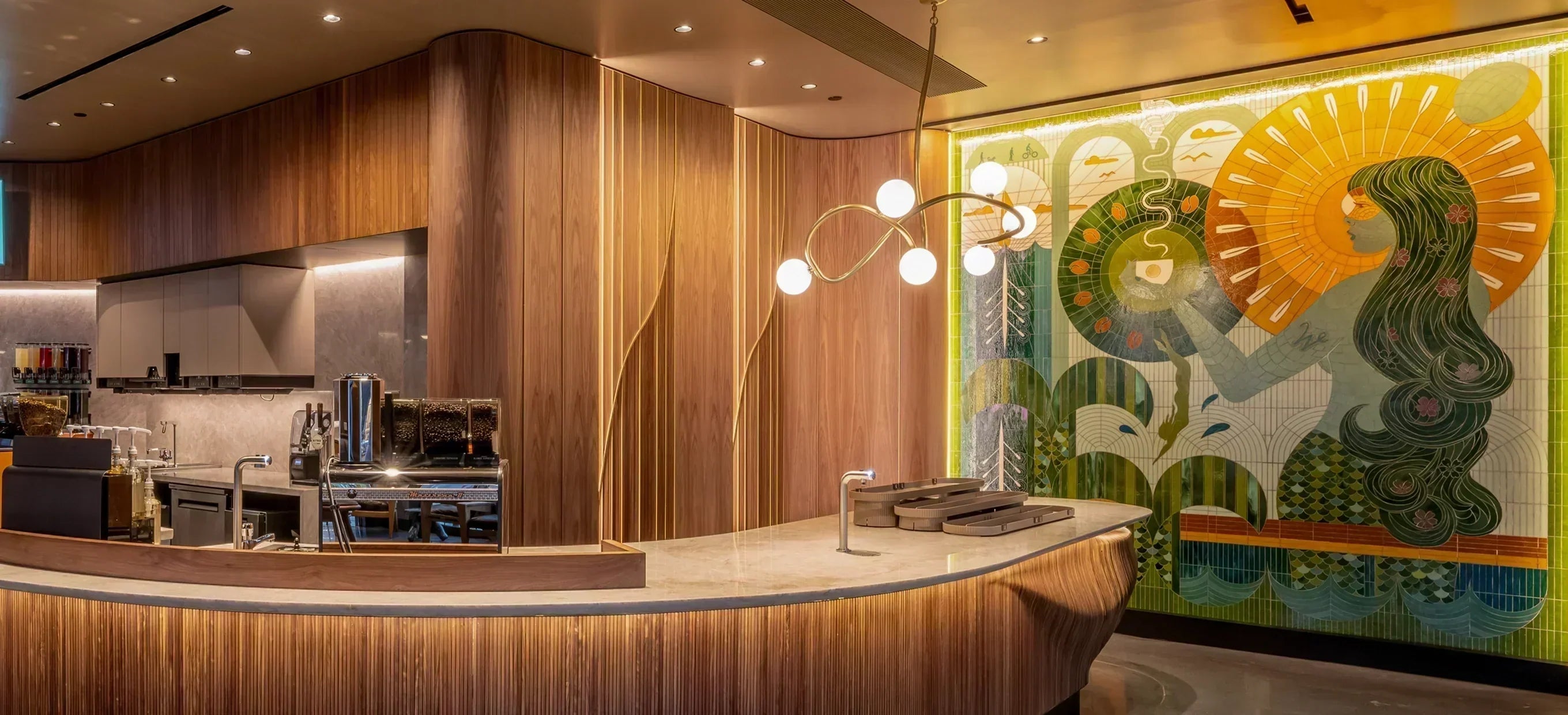 Modern kitchen with wooden cabinets and a decorative wall mural.
