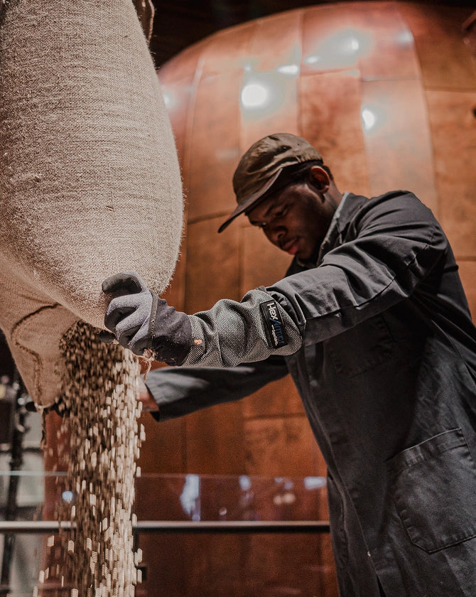 A person working with coffee beans at a Starbucks Reserve Roastery.