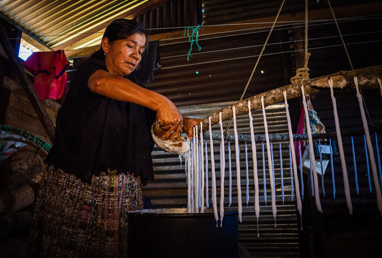 Woman melting wax to create candles.