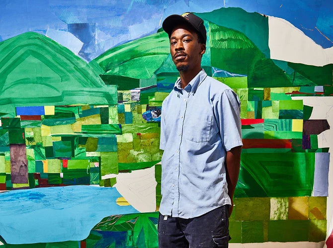 The artist, Hampton Boyer, standing in front of his colourful abstract artwork.