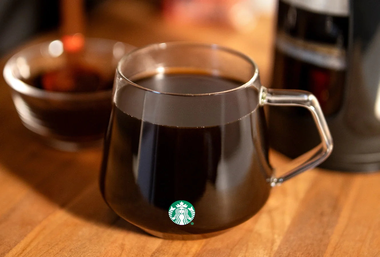 Close-up of a Starbucks Glass Mug filled with coffee.