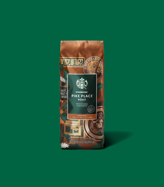Starbucks Pike Place Roast coffee bag on a green background.