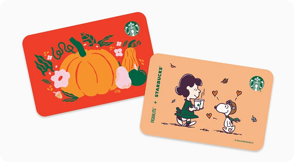 Two Starbucks gift cards with Peanuts artwork, one red with a pumpkin illustration and one peach with Snoopy and Woodstock, shown on a light gray background.