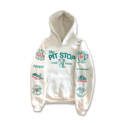 An off-white hooded sweatshirt with a colorful graphic print featuring 'The Pit Stop' and various cartoon illustrations on both sleeves, shown against a plain white background.