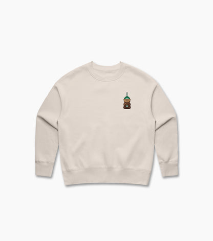Beige sweatshirt with a small embroidered design on a white background