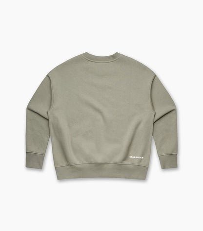 Back view of an olive-green women’s crewneck sweatshirt with a small white ‘STARBUCKS’ logo printed near the lower right hem.