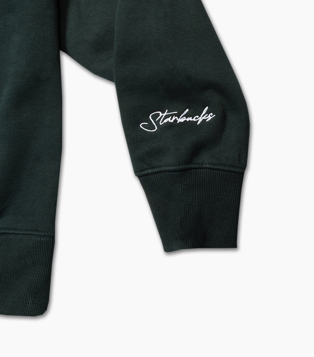 Dark green sweatshirt sleeve with 'Starbucks' logo on a light gray background