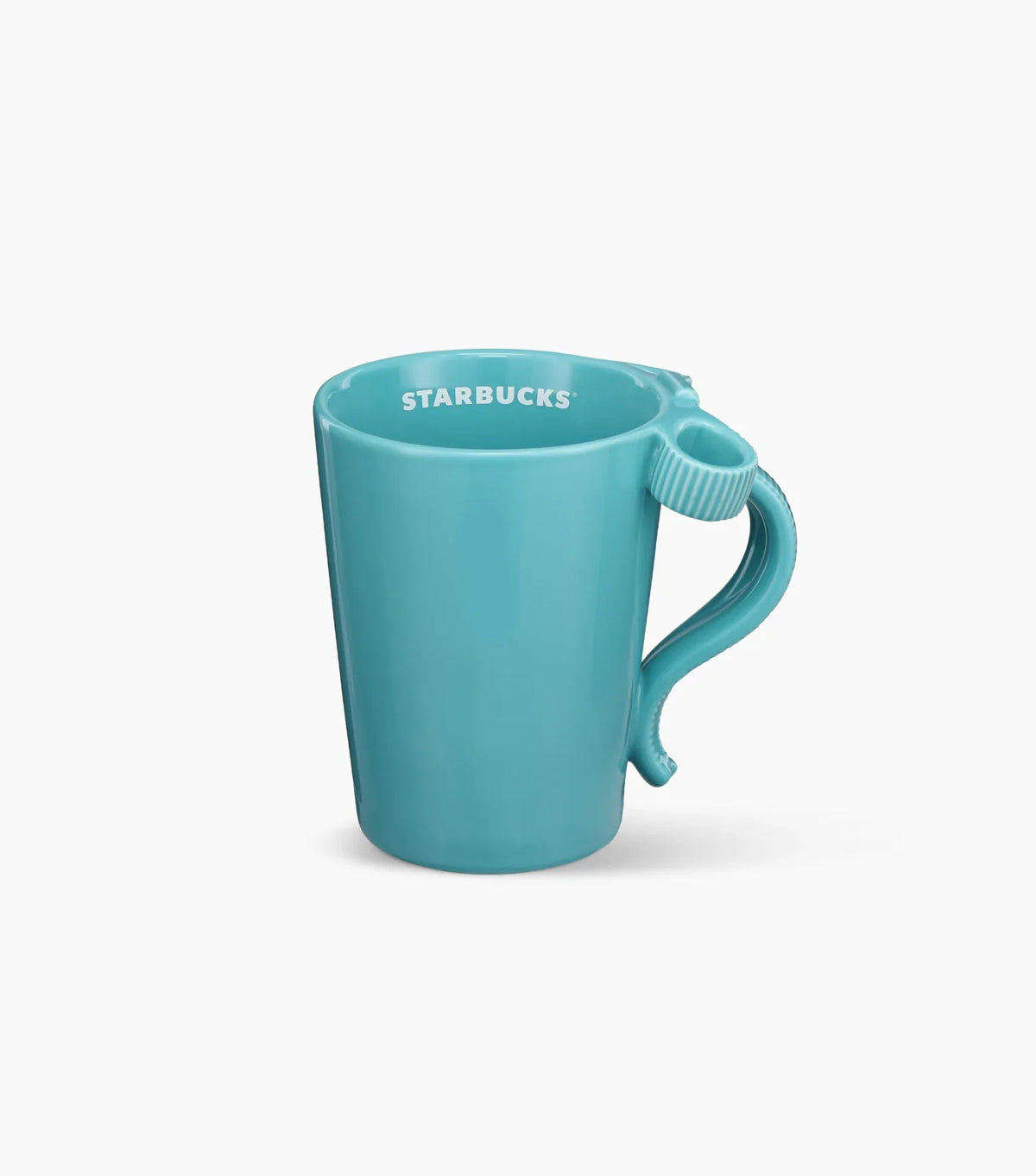 A glossy teal ceramic mug featuring a sculpted bow-shaped handle and the Starbucks logo printed inside the rim.