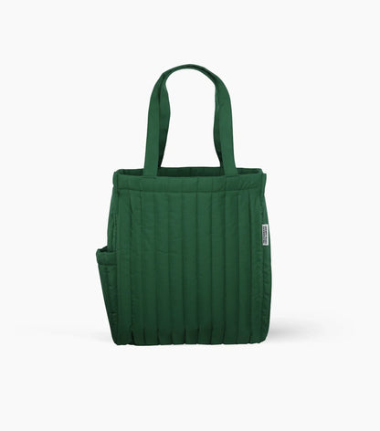 A quilted dark-green tote bag with long handles, vertical padded stitching, and an exterior side pocket.