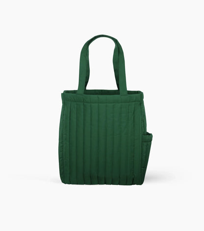 A quilted dark-green tote bag with long handles, vertical padded stitching, and an exterior side pocket.