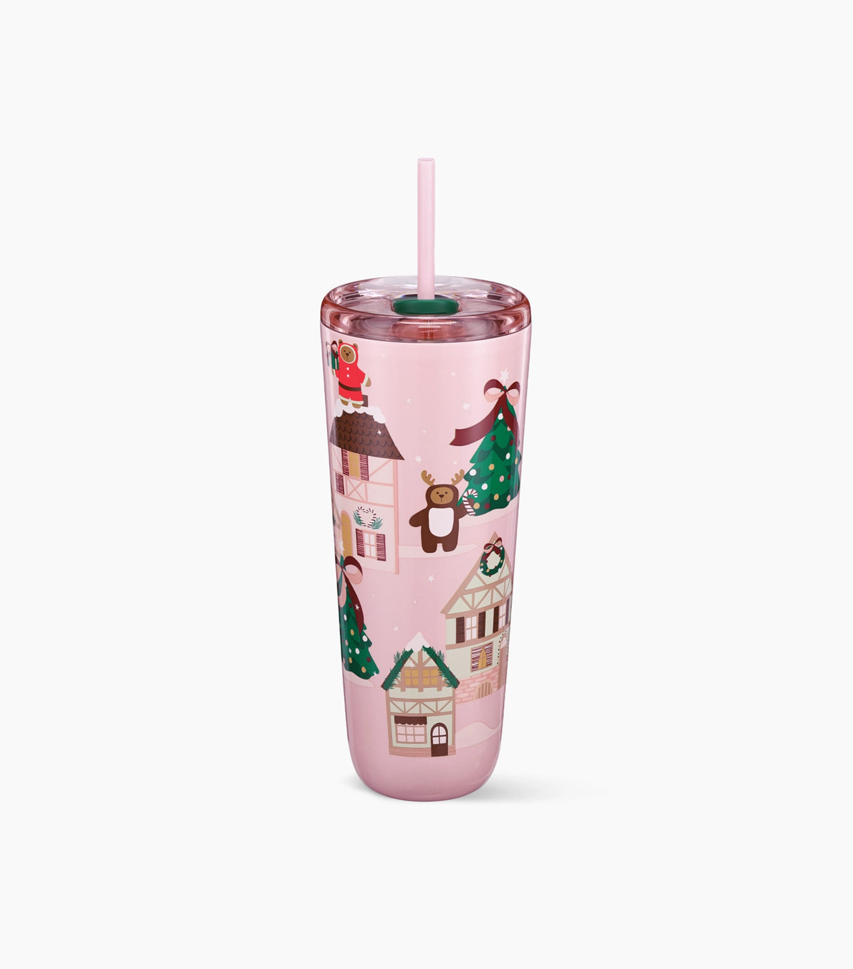 A pink tumbler with a straw lid and a pattern of winter houses, Christmas trees and bears, shown on a clean white background.