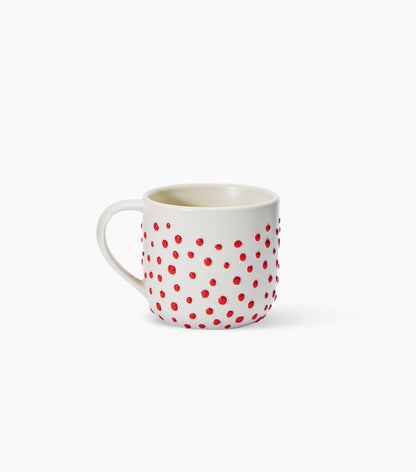 A white ceramic mug patterned with 3d red ceramic dots, on a clean white background