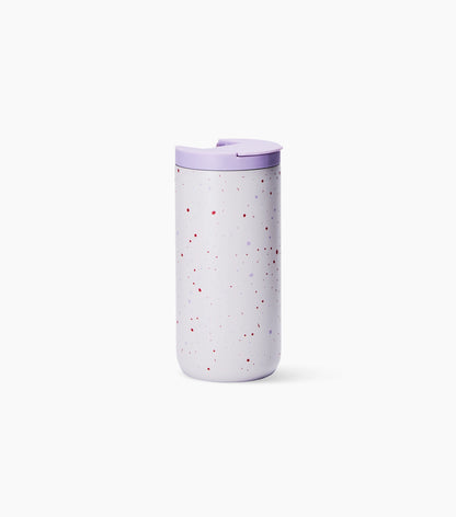 A light lavender insulated travel tumbler with a matching lavender lid and subtle red and blue speckles, set against a clean white background.