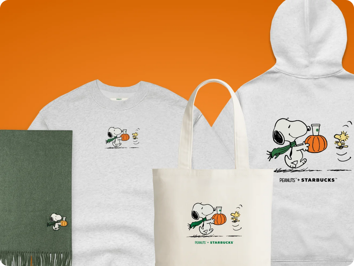 A coordinated apparel and tote set featuring Snoopy and Woodstock graphics. The set includes a white crewneck sweatshirt, a white hoodie, a white tote bag, and a dark green scarf, all styled against a solid orange background.