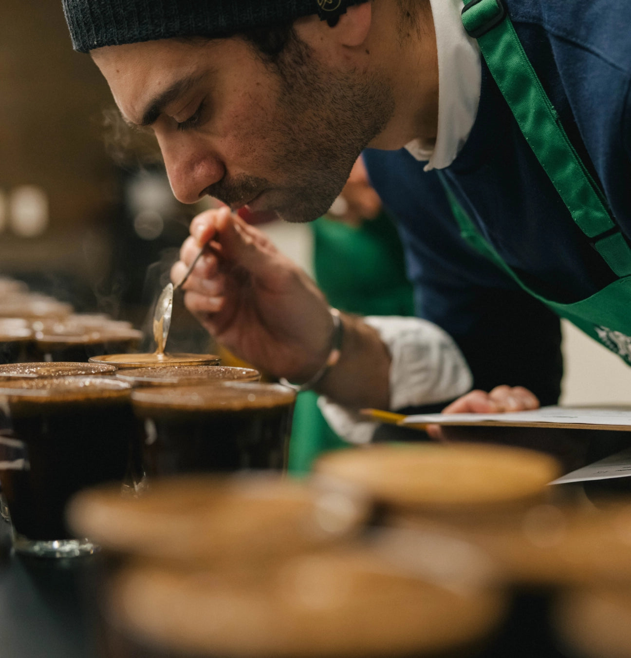 Barista tasting coffee in a professional setting