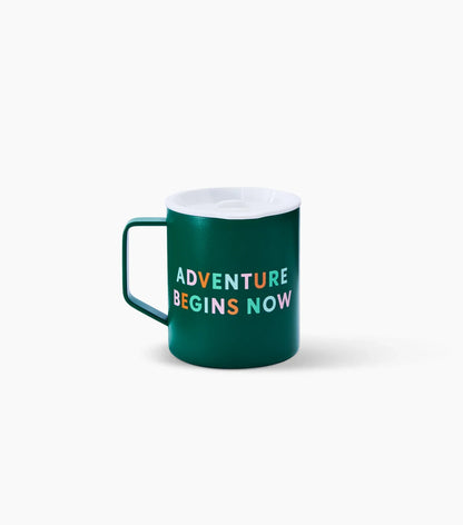 Green mug with 'ADVENTURE BEGINS NOW' text on a white background