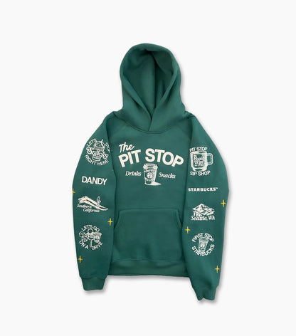 A dark green pullover hoodie with white graphic prints and text on both sleeves and the chest, including 'The PIT STOP' and 'STARBUCKS', shown on a light gray background.