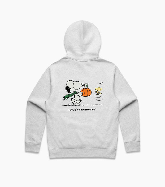 A light gray heather pullover hoodie shown from the back, featuring a cartoon graphic of Snoopy holding a pumpkin and a green scarf, with the text 'SNOOPY x STARBUCKS' printed below.