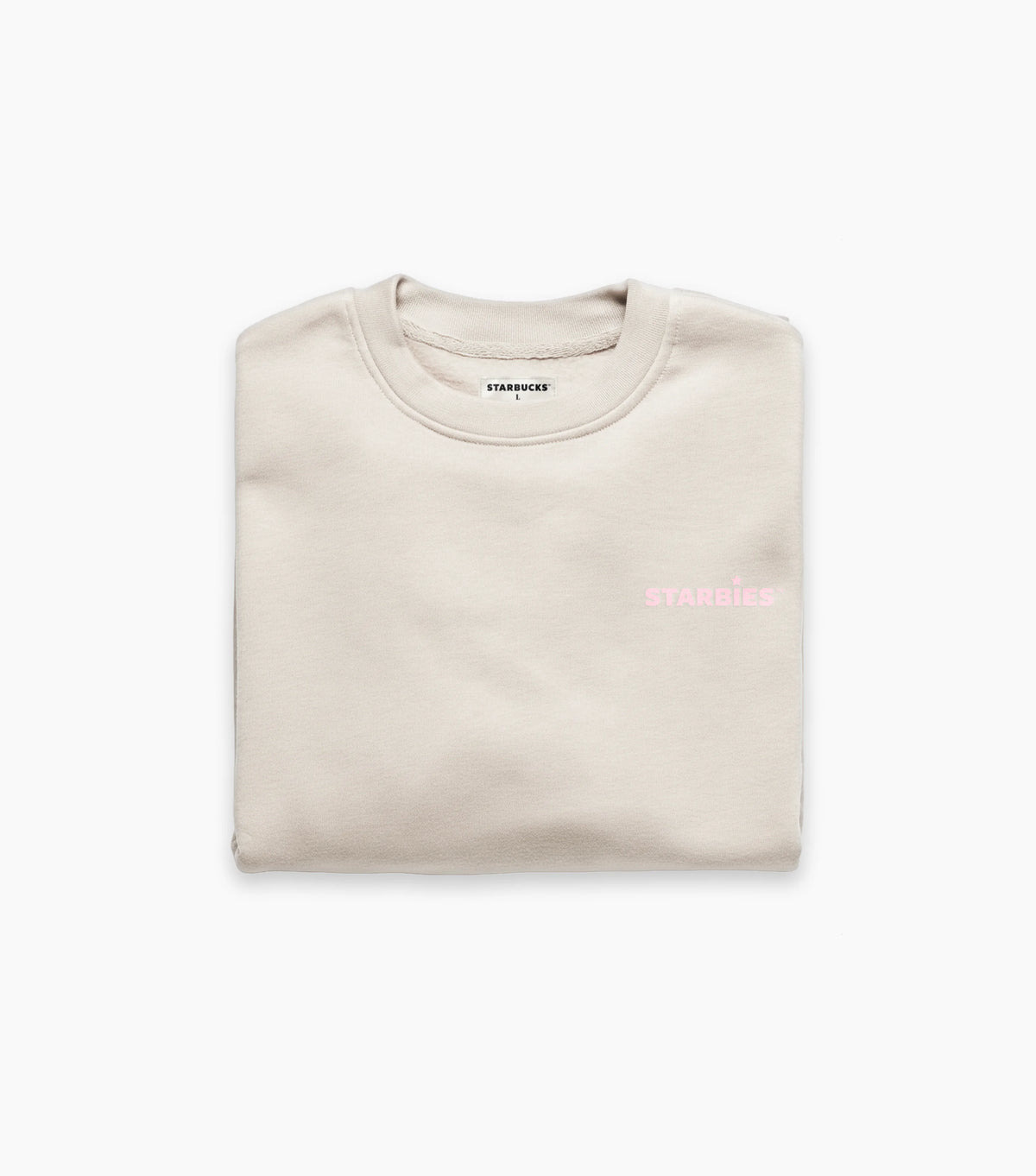 Folded beige crewneck sweatshirt with pink Starbies text on a white background