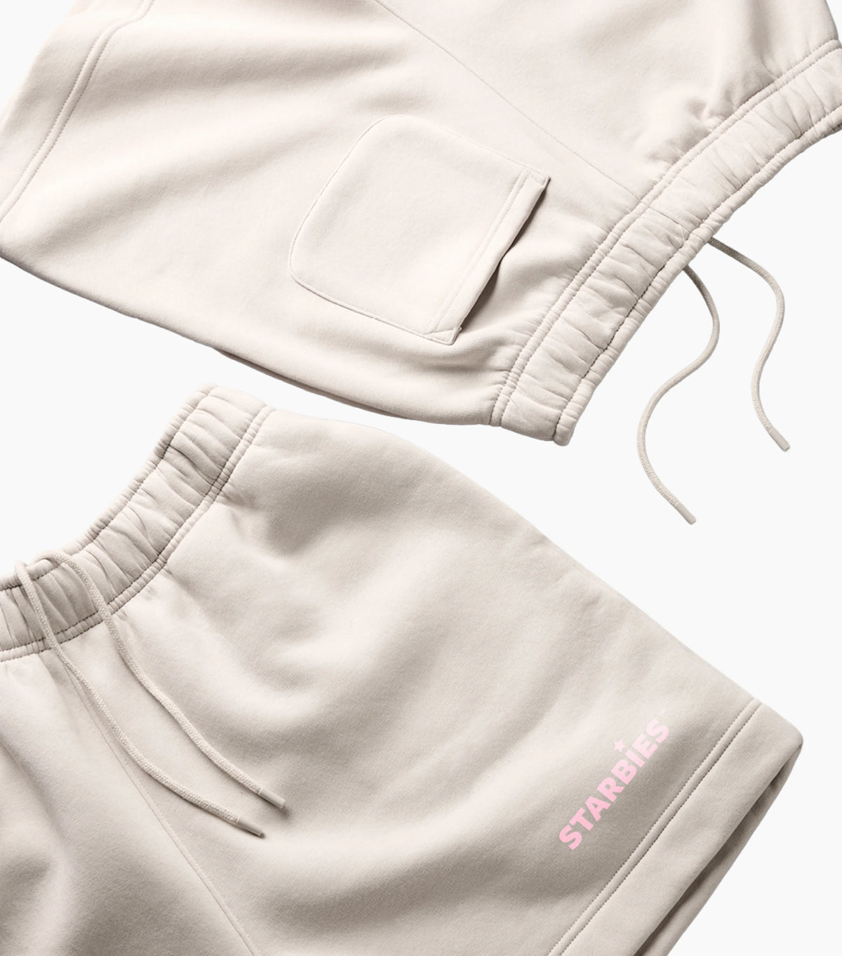 Beige sweatshirt and shorts set with pink 'STARBIES' branding on a light background