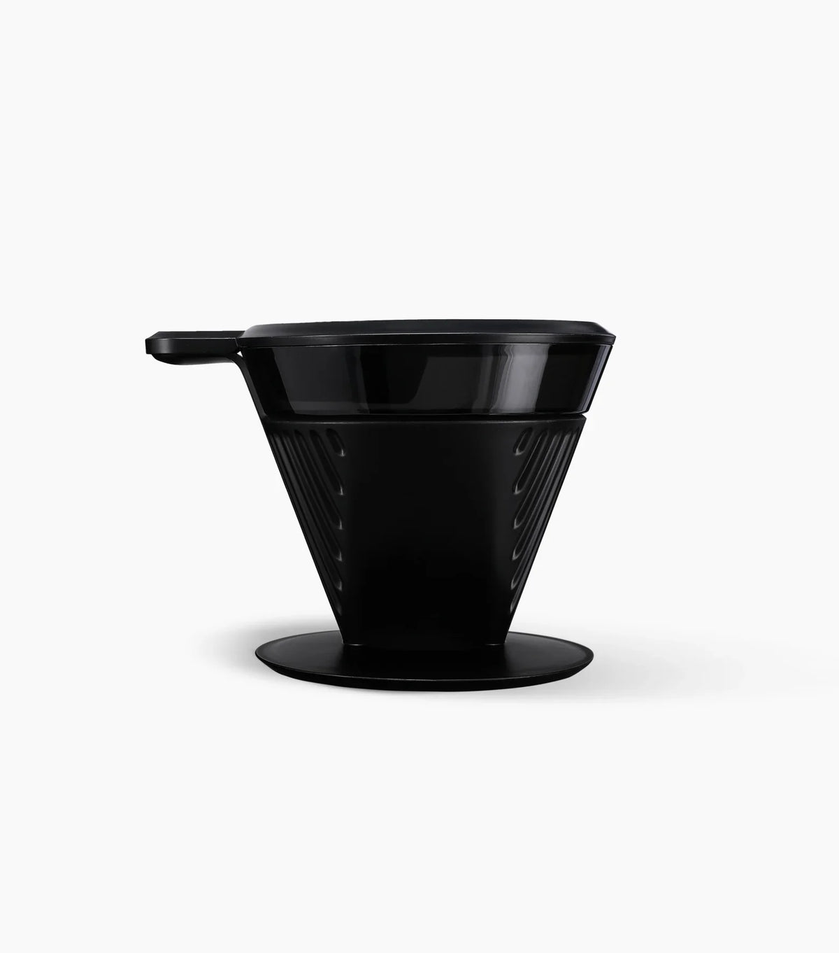 Black plastic Starbucks Pour-Over Brewer with handle towards the left, on a white background.