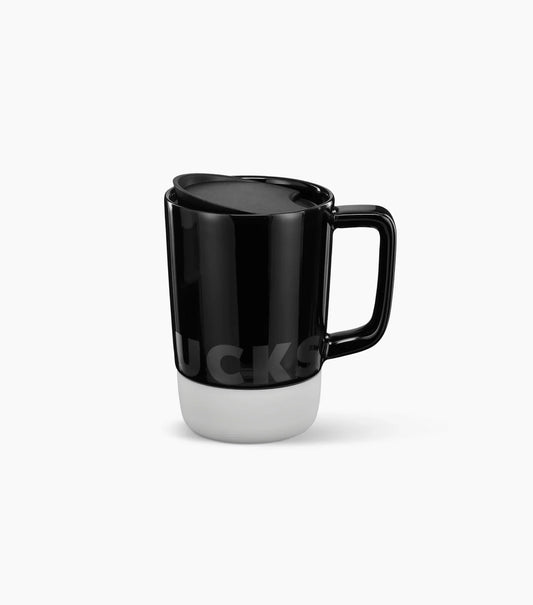Starbucks Ceramic Desktop Mug - with a black top half featuring the Starbucks brand name logo, and a white bottom half (shown with handle to the right) on a white background.
