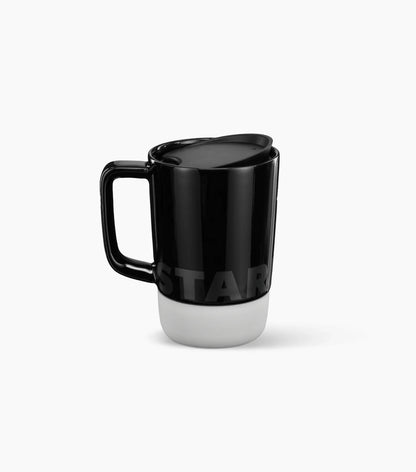 Starbucks Ceramic Desktop Mug - with a black top half featuring the Starbucks brand name logo, and a white bottom half (shown with handle to the left) on a white background.