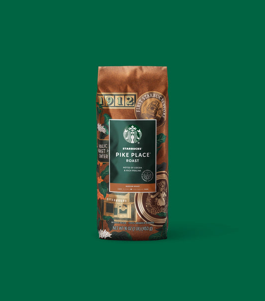 Starbucks Pike Place Roast coffee bag on a green background.