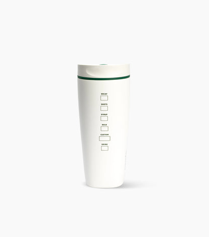 A tall white travel tumbler with a matching white lid and a thin dark green accent line near the top. The front features a vertical measurement scale with labels for Break, Snack, Meal, Milk, Juice, Coffee, and Tea, each accompanied by a small square marker box.