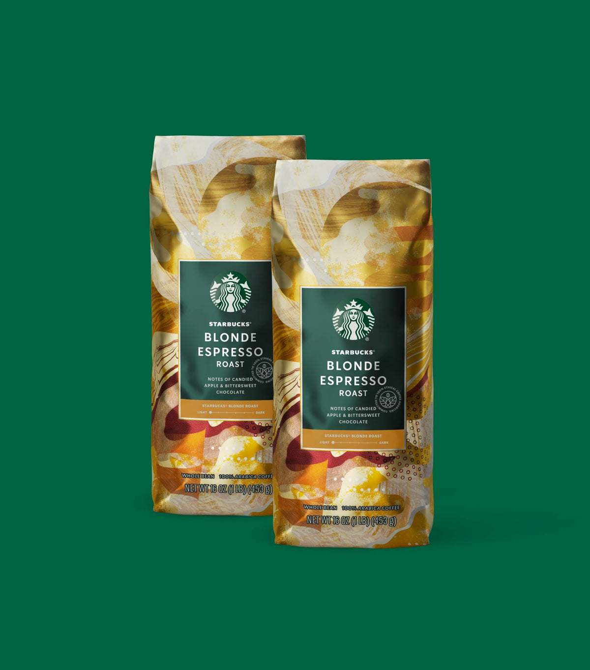 Two Starbucks Blonde Espresso Roast coffee bags on a light green background.