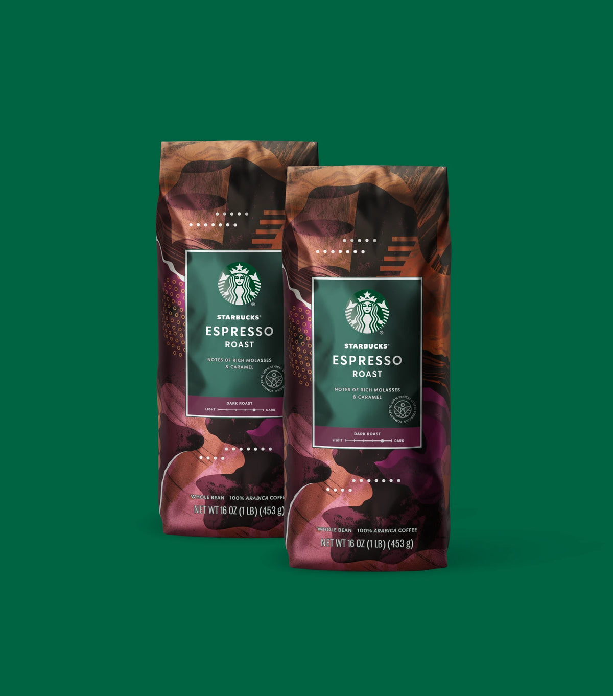 Two Starbucks Espresso Roast coffee bags on a light green background.