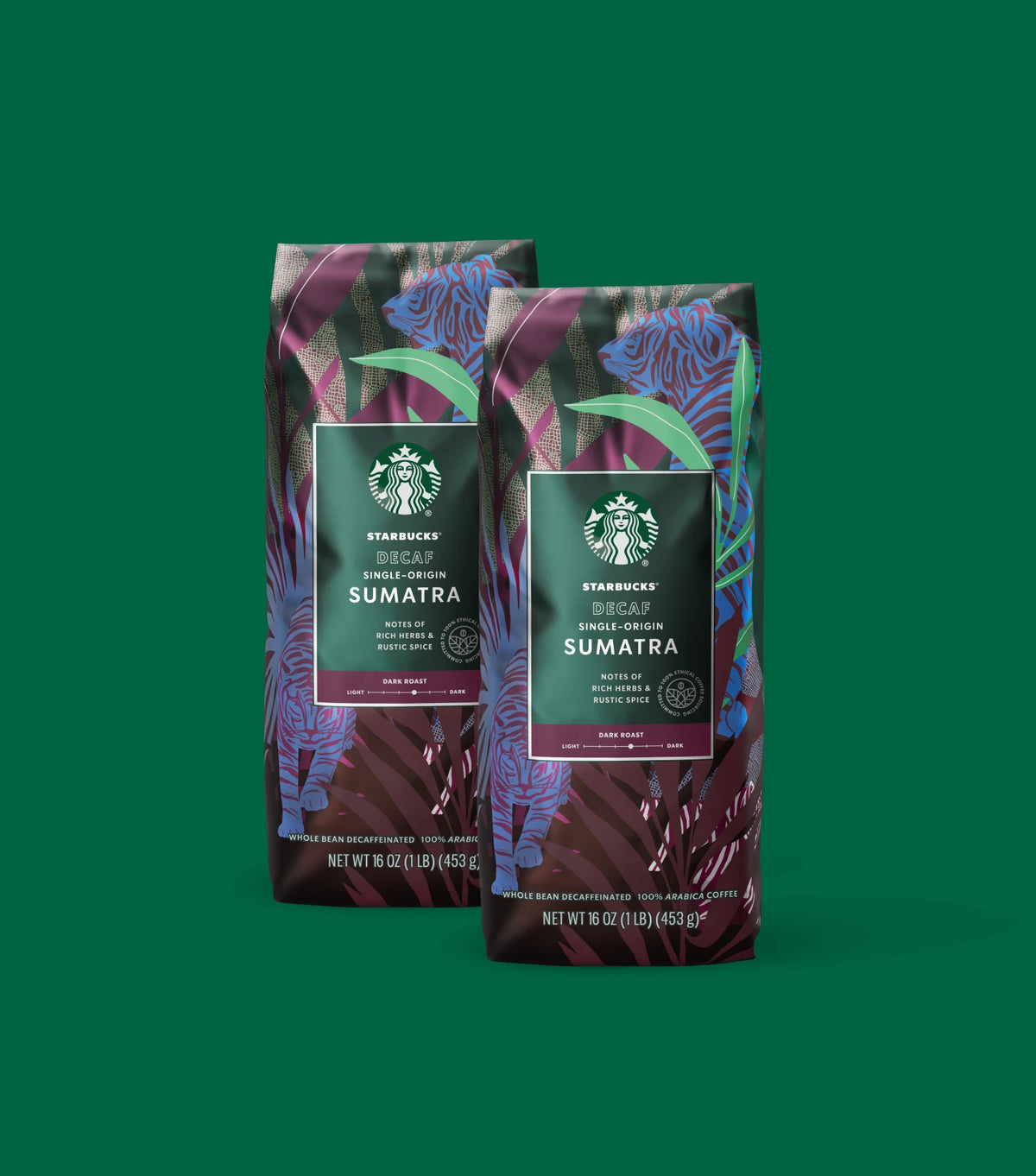 Two Starbucks Decaf Single-Origin Sumatra coffee bags on a green background.