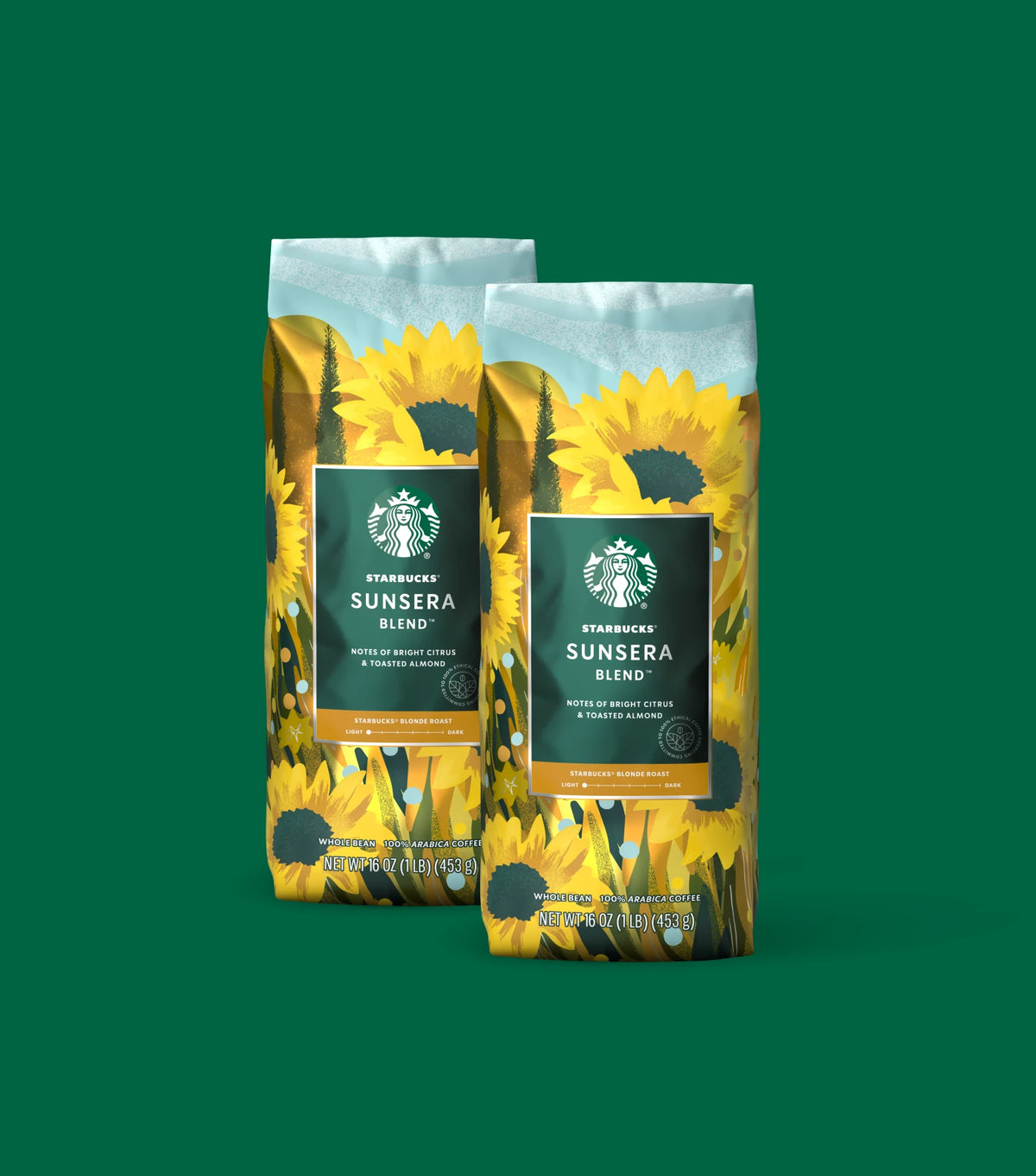 Two Starbucks Sunsera Blend coffee bags with sunflower design on a green background.