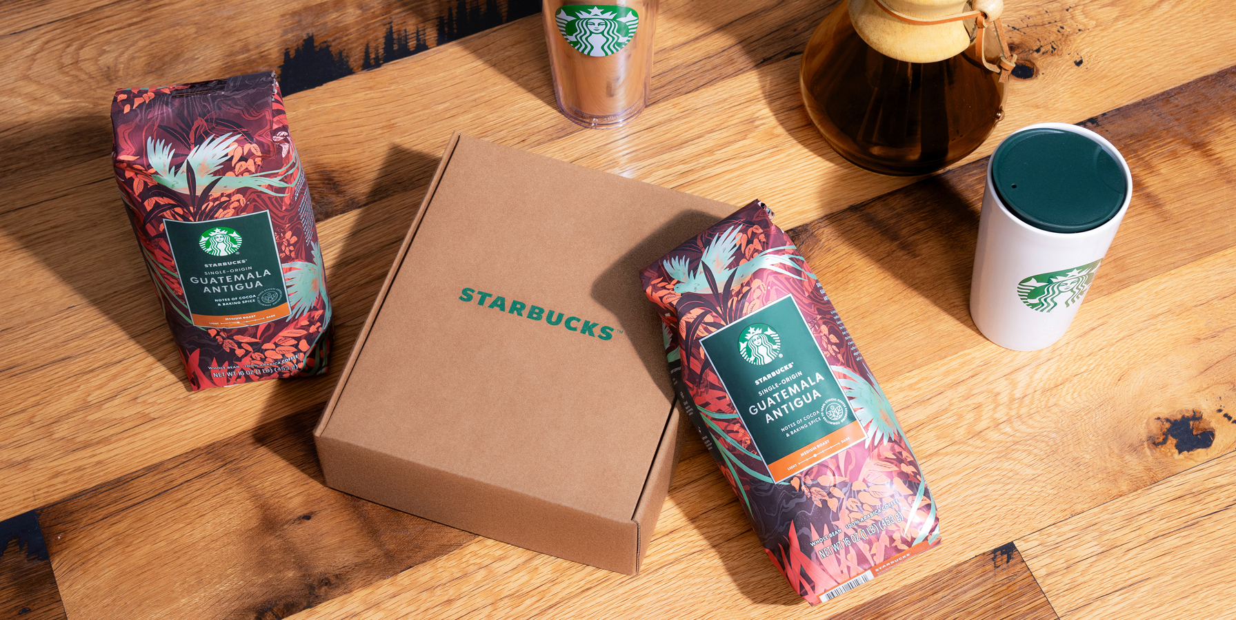 Starbucks subscription box with two bags of Starbucks Single-Origin Guatemala Antigua coffee on a wooden surface.