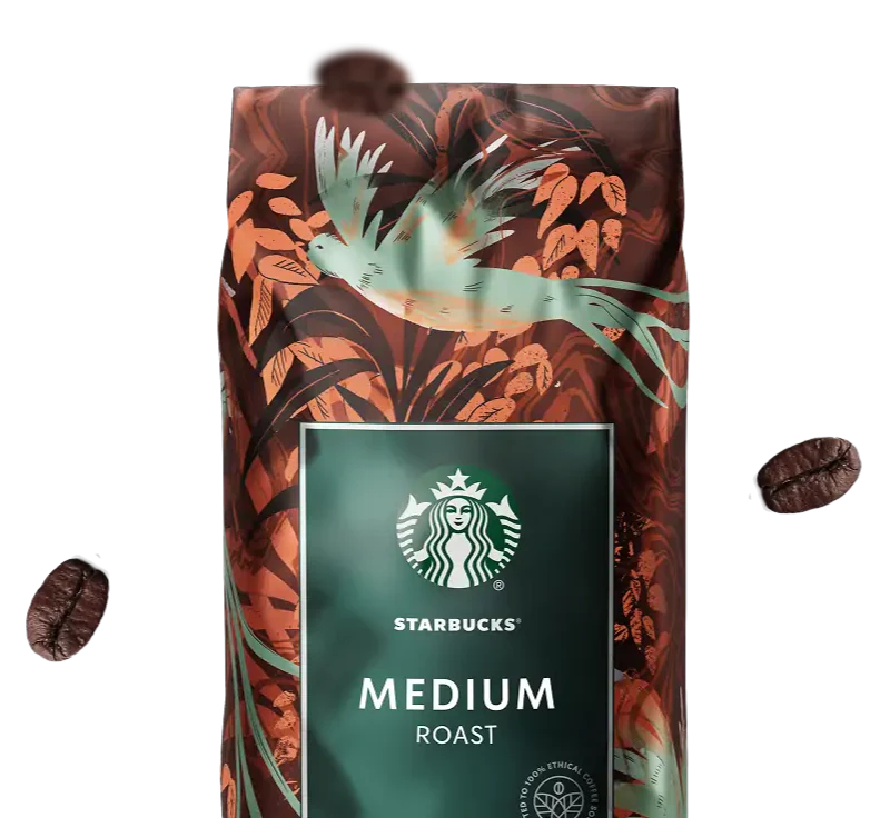 Starbucks Medium Roast coffee bag with decorative design and floating coffee beans against the background.